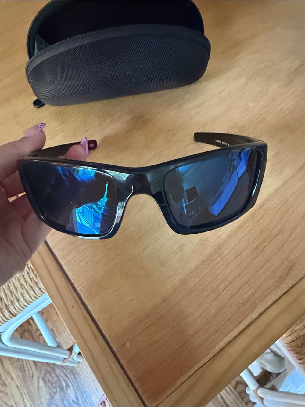 Oakley Black Frame Sunglasses with Blue Mirrored Lenses